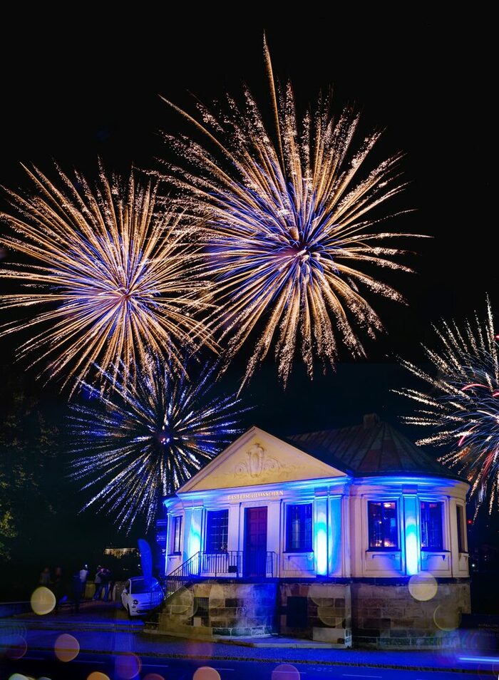 Außenansicht des Basteischlösschens bei Nacht, in dem sich der neue KOBALT Club Royal befindet. Das Gebäude wird blau angestrahlt und ein Feuerwerk findet statt.Im Hintergrund sind die Frauenkirche und Brühlsche Terrasse zu erkennen.